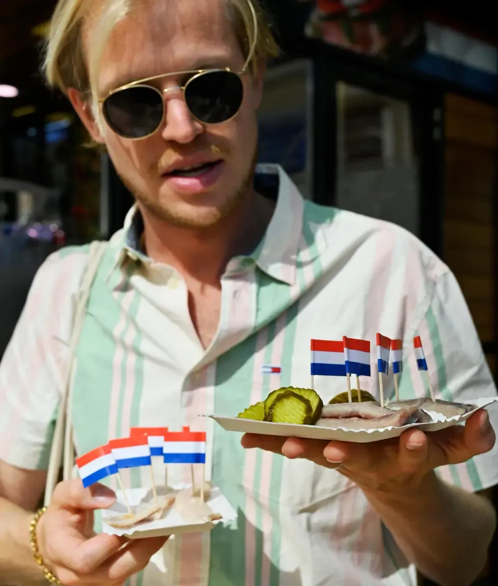 man holding local cuisine with flag on top