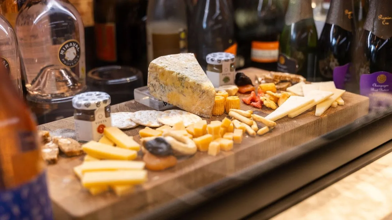 Wine glasses and assorted Dutch cheeses arranged on a tasting platter.