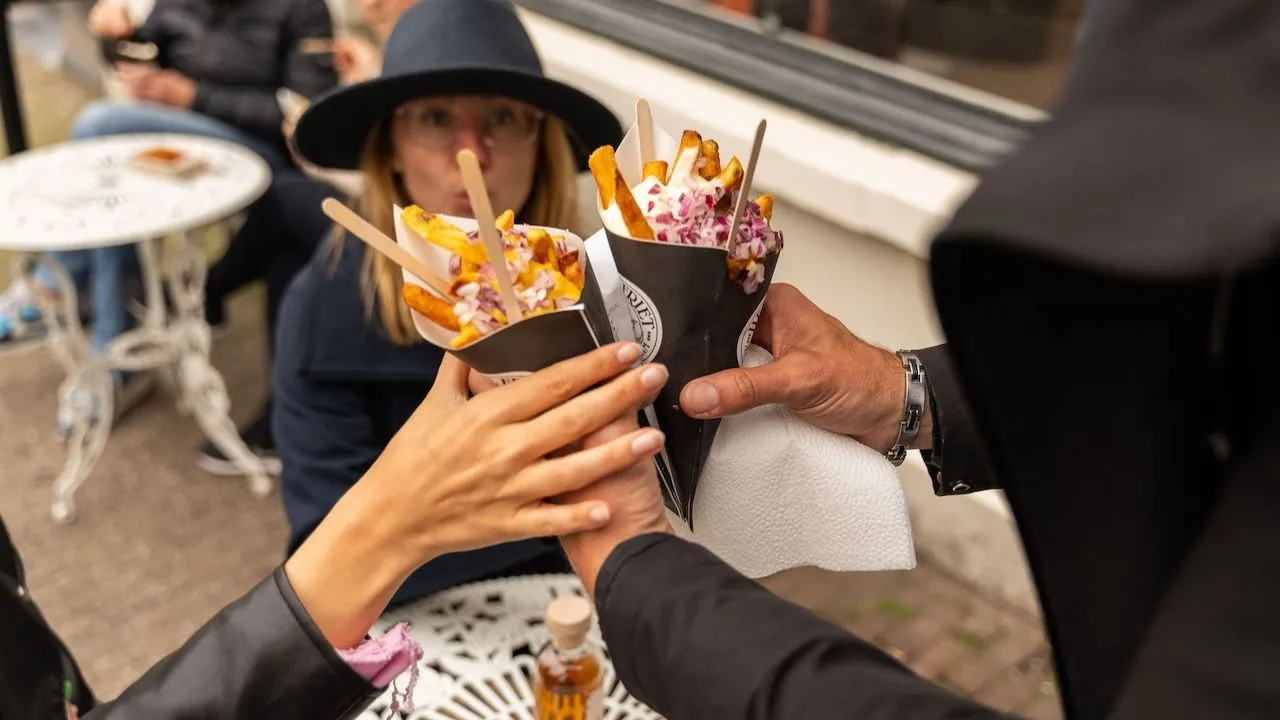 Dutch fries served with mayonnaise, enjoyed by friends in Amsterdam