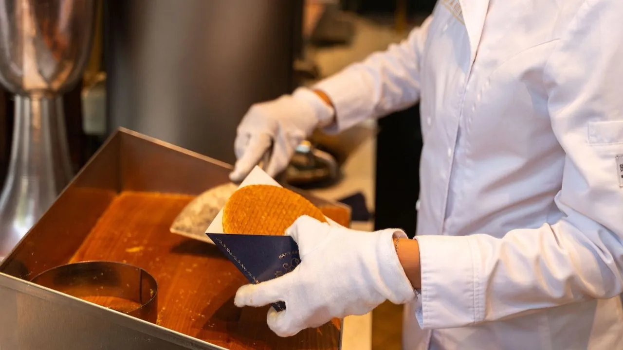Chef preparing fresh stroopwafels on a hot waffle iron