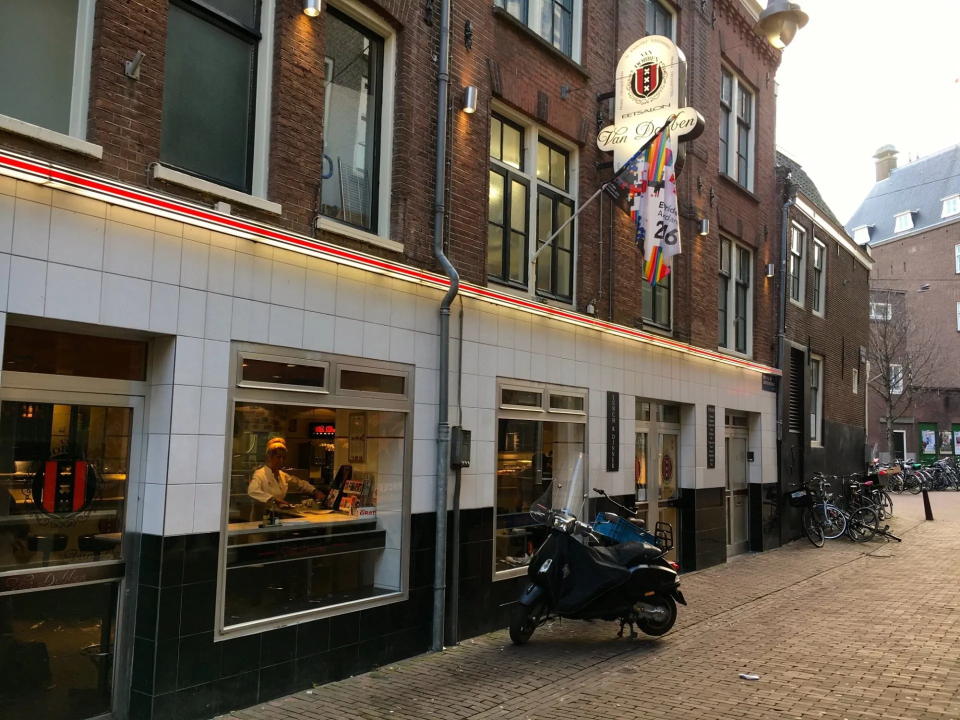 Exterior of Eetcafe van Dobben in Amsterdam, a brown cafe with its sign on a quiet street