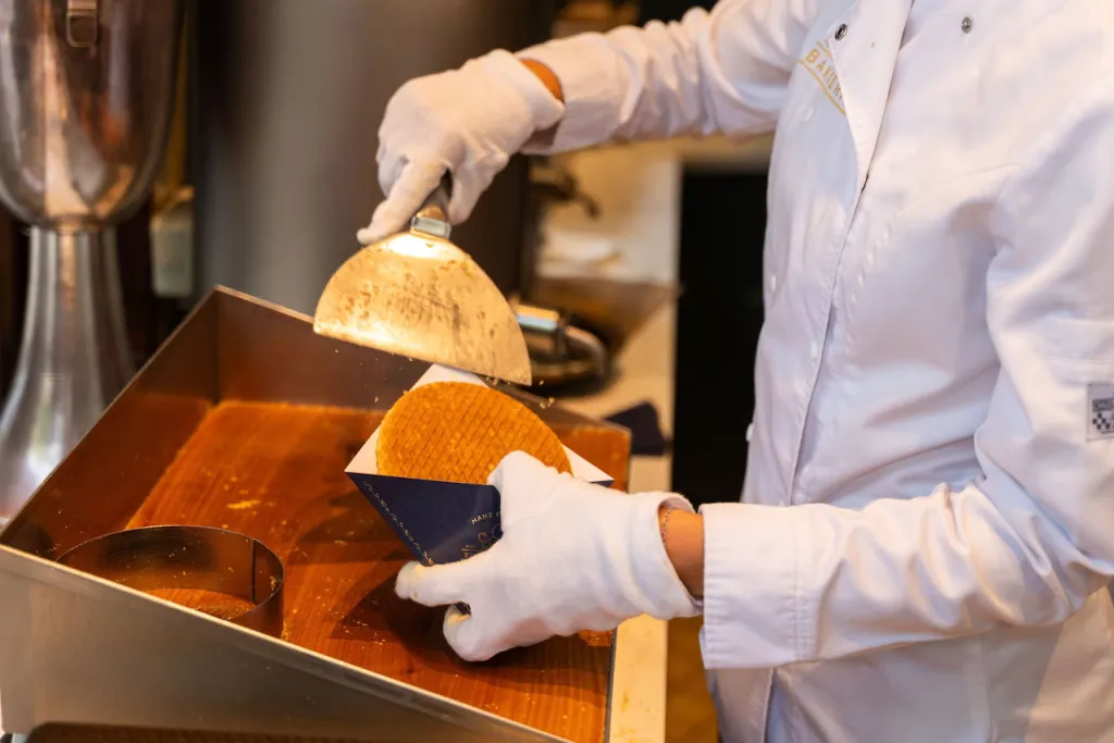 Fresh stroopwafel pressed at an Amsterdam market stall