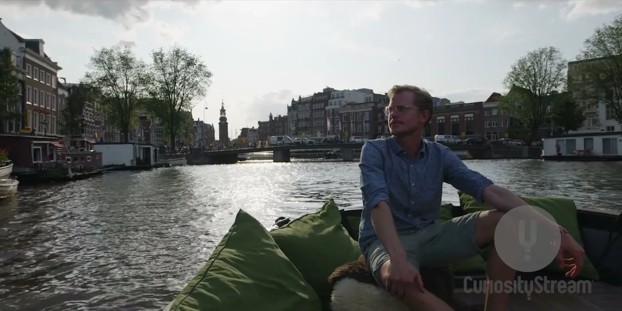Otto on a canal boat in Amsterdam, filming for CuriosityStream's The History of Home