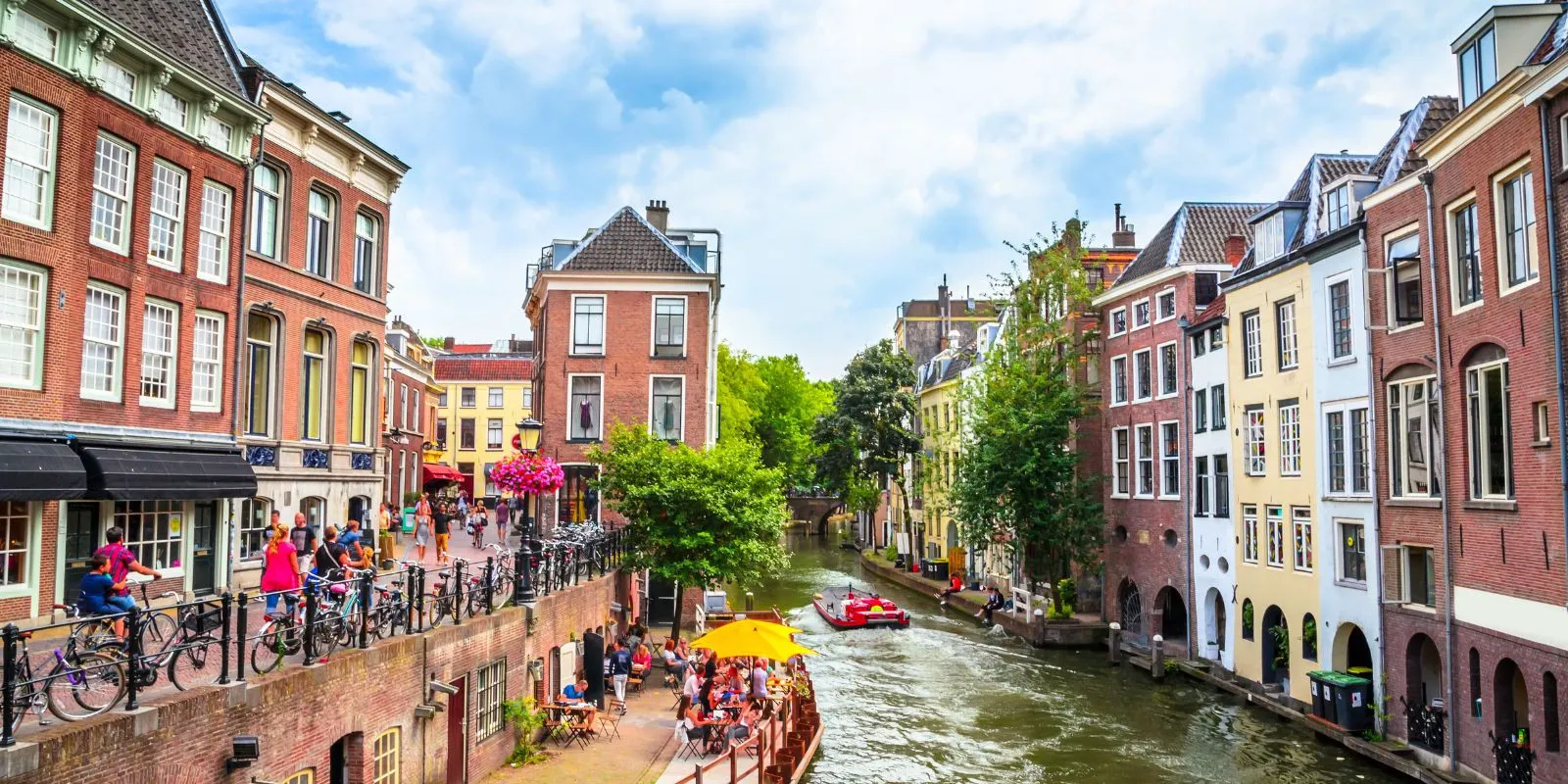 Utrecht's Oudegracht canal in summer with busy wharf terraces below the street